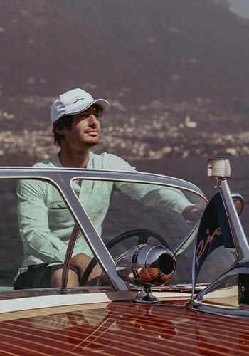 Man aboard a luxury wooden boat in Lake Como